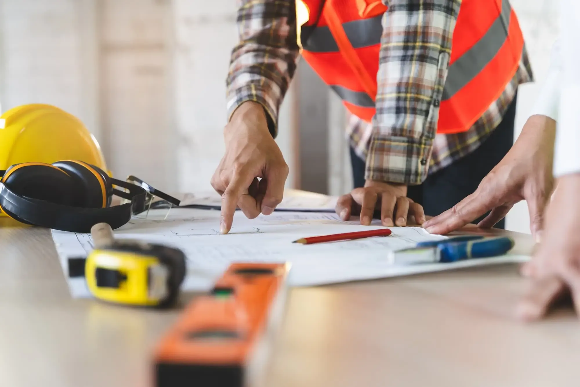 Construction site supervisor reviewing plans during a residential build in Nicaragua